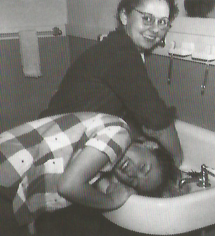 A pair of students washing their hair in a sink in 1953.